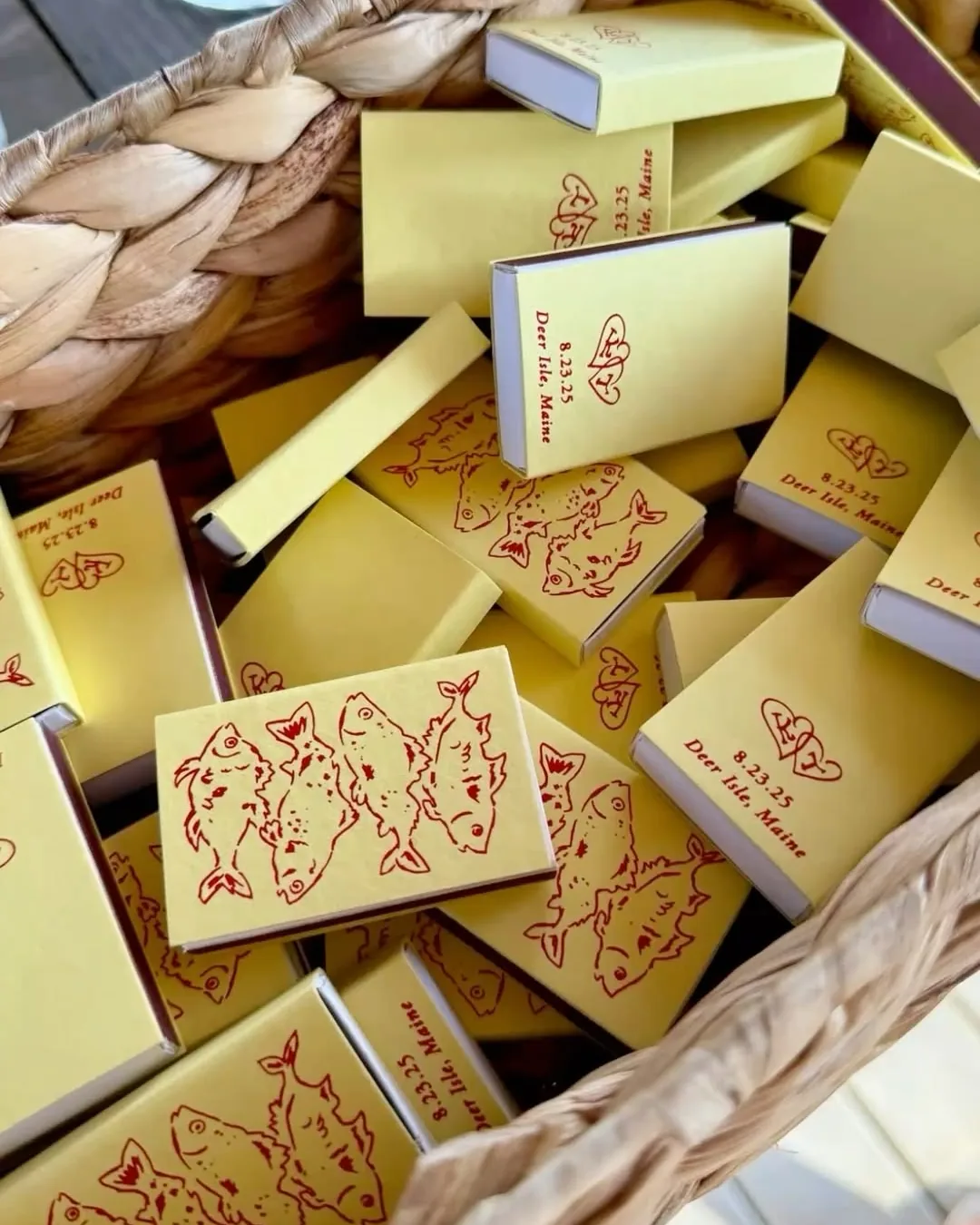 Yellow matchboxes drawn with red fish in a woven basket