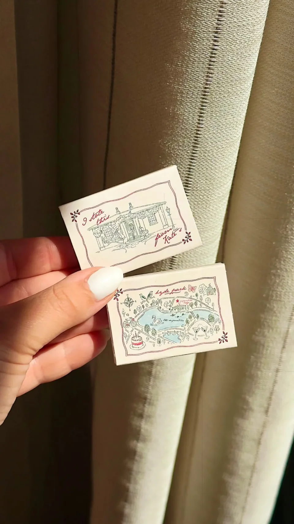 Cream matchboxes with a house in red and green line and a small illustrated park map