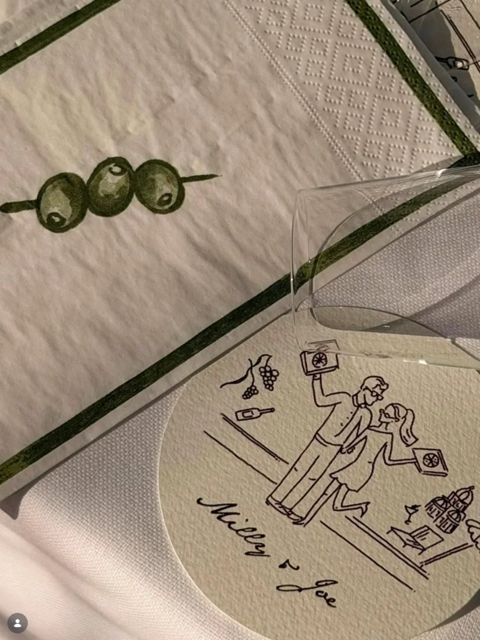 Illustrated wedding napkin and personalised coaster arranged as a coordinated table setting