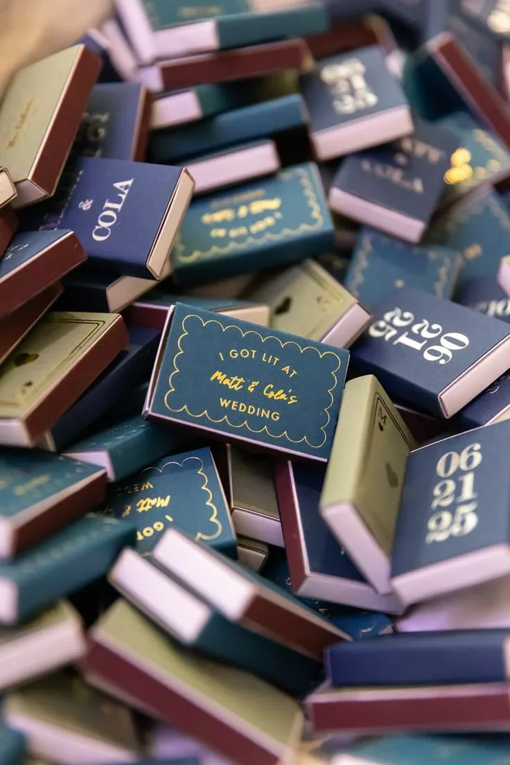 A table covered in coloured illustrated matchboxes