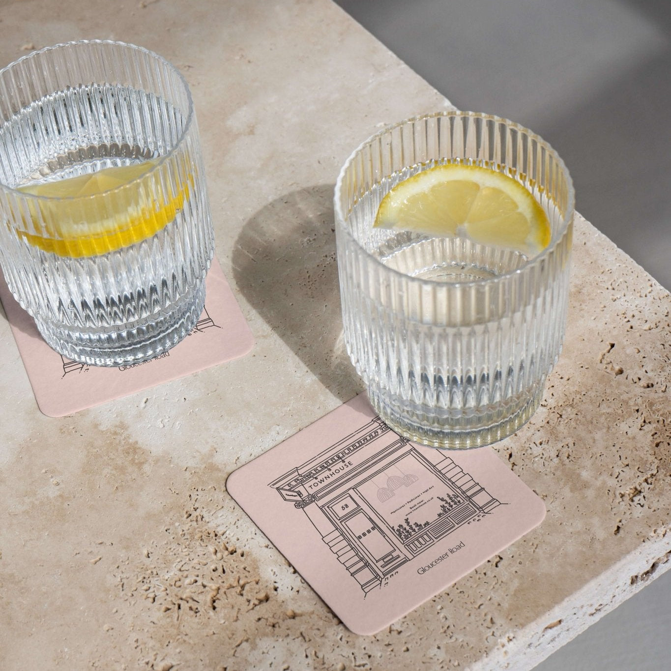 Illustrated coasters arranged for an intimate table