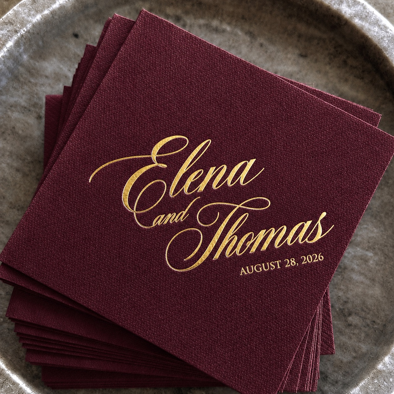 Burgundy napkins finished with elegant gold lettering
