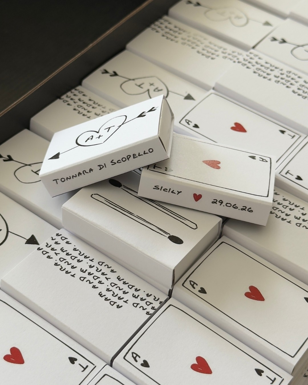 A tray of A and T personalised wedding matchboxes dated 29 June 2026